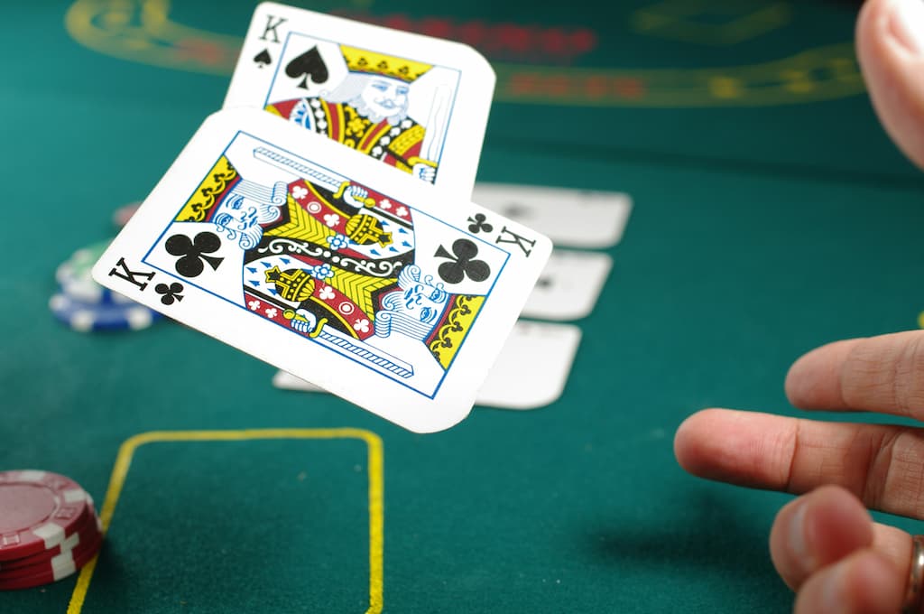 Person throwing cards in game of poker