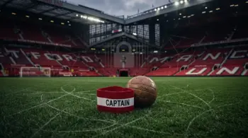 Manchester United football and captain’s armband symbolising Bruno Fernandes staying at Old Trafford