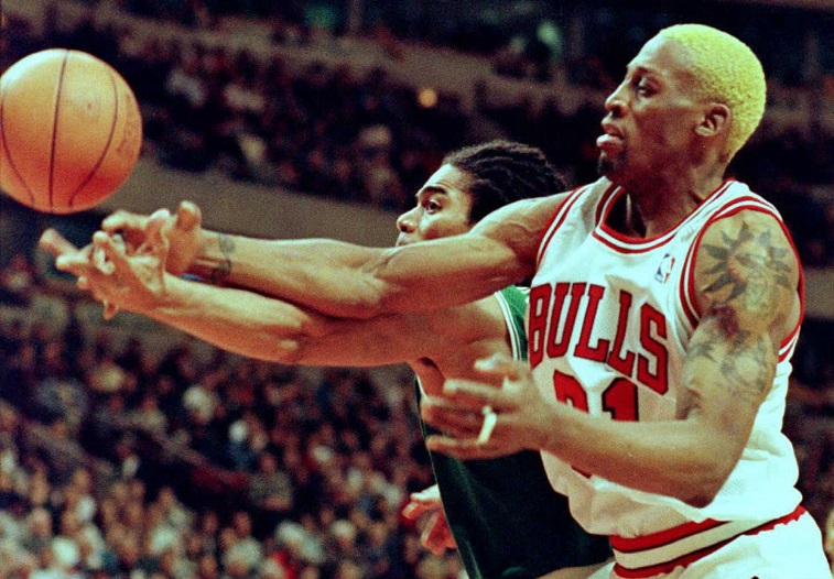 Dennis Rodman fights for control of the ball during a game