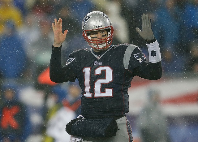Tom Brady holds up his hands and signals to his offense.