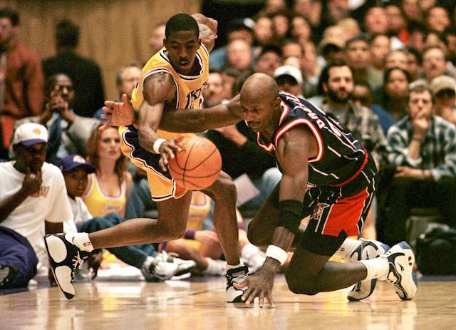 Clyde Drexler (R) and Eddie Jones fight for the ball