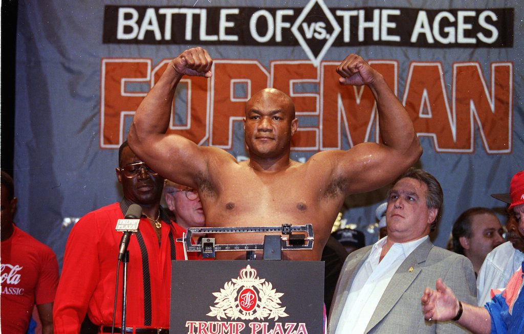 George Foreman flexes for members of the press.