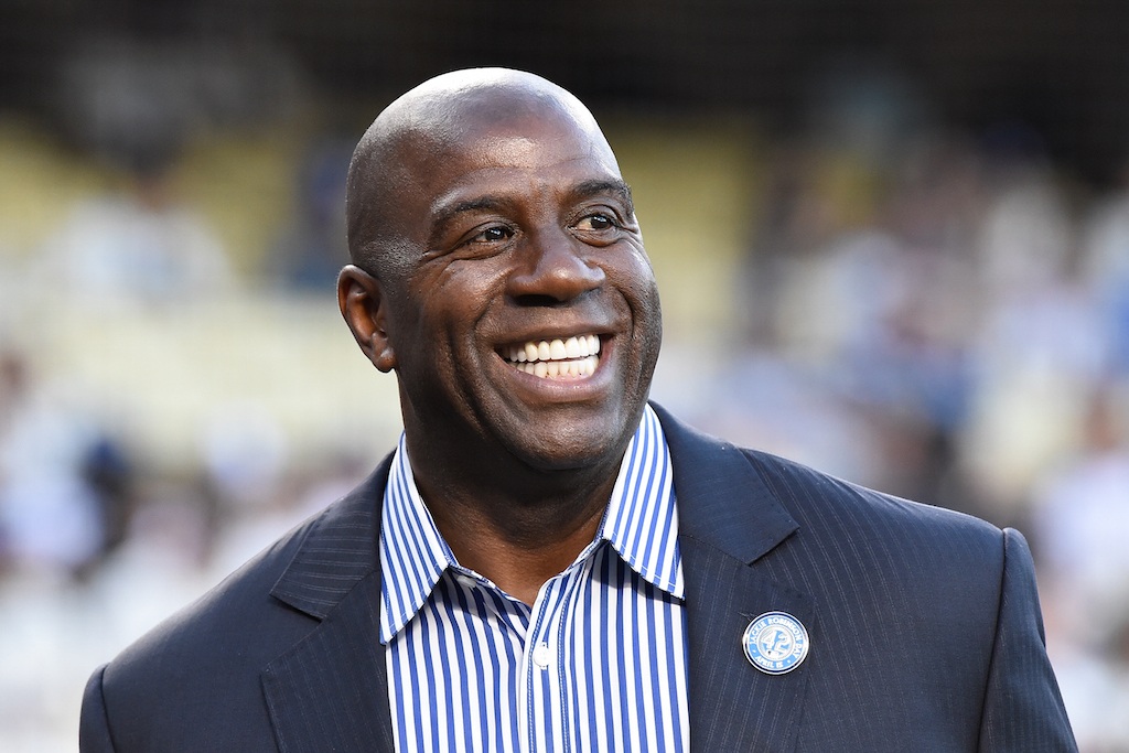 Magic Johnson smiles during a Lakers game.