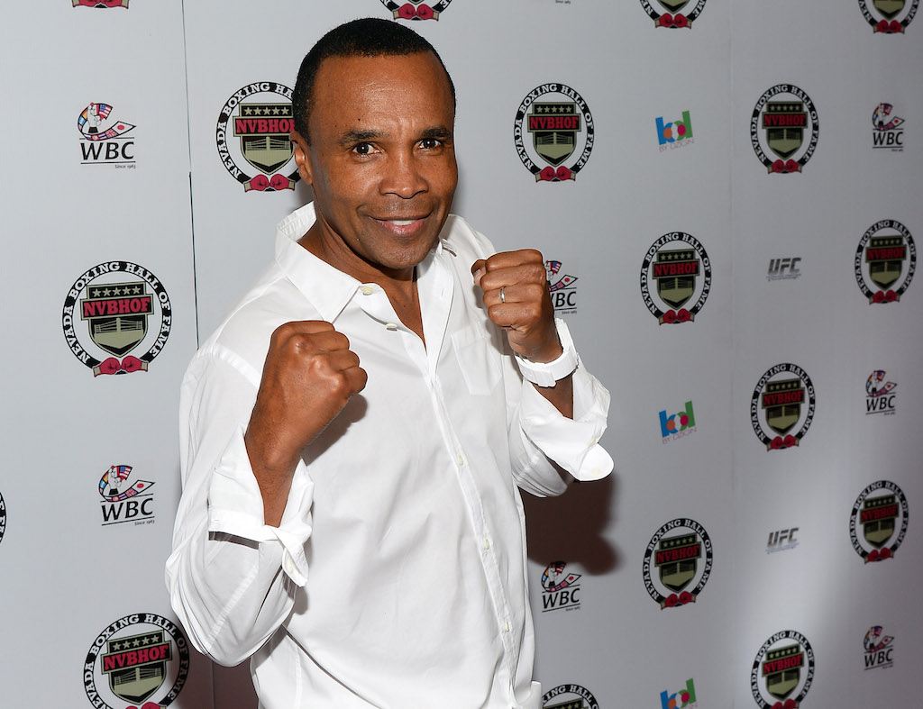 Sugar Ray Leonard holds his fists up during a media event.