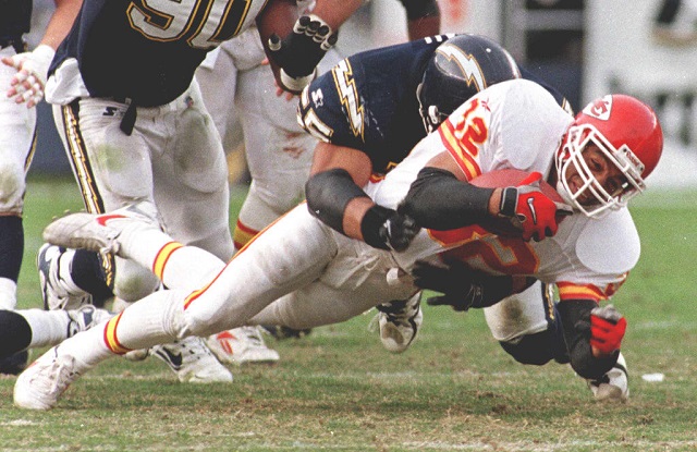 SAN DIEGO, : Kansas City Chiefs running back Marcus Allen is brought down by San Diego Chargers Junior Seau after a short gain in the 3rd quarter 14 December. Allen scored a touchdown in the 2nd quarter to help the Chiefs defeat the Chargers 29 to 7 and improved their record to 12-3. AFP PHOTO/Mike NELSON (Photo credit should read MIKE NELSON/AFP/Getty Images)Mike Nelson/AFP/Getty Images
