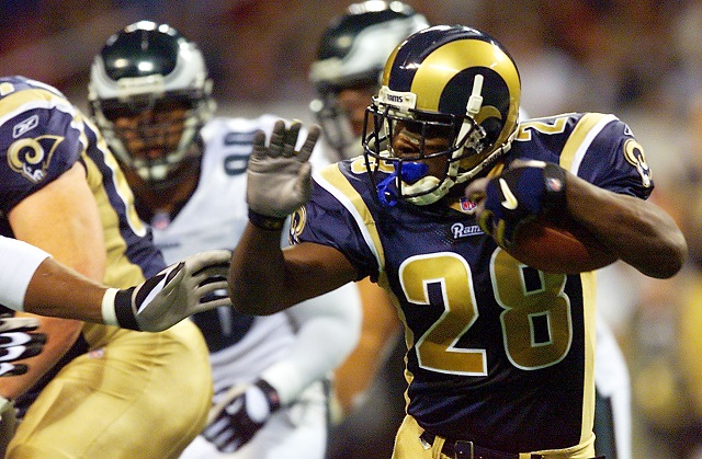 ST LOUIS, : Runningback Marshall Faulk of the St. Louis Rams runs against the Philadelphia Eagles 27 January, 2002 during the NFC Championship game at the Edward Jones Dome in St. Louis, MO. The Rams won 29-24 and went on to face the New England Patriots in the Super Bowl 03 February, 2002.