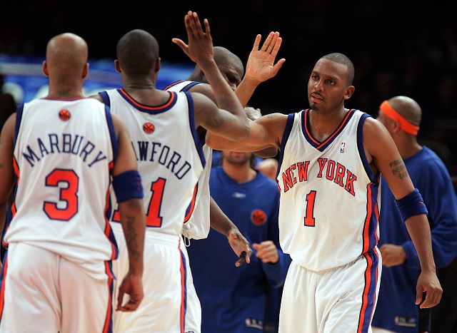 Stephon Marbury of the New York Knicks high-fives his teammates. 