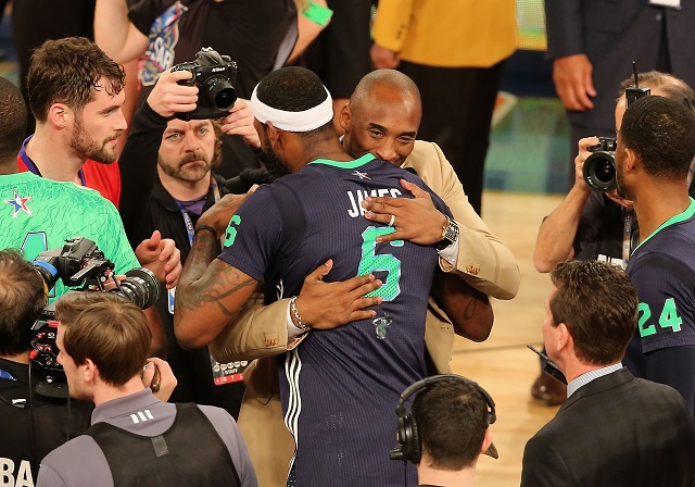 Kobe Bryant and LeBron James hug after an All-Star game.