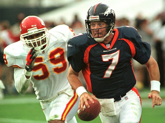DENVER, CO - JULY 8: Denver Broncos quarterback John Elway scrambles for yardage as he is pursued by Kansas City Chiefs linebacker Donnie Edwards during the Broncos season opener against the Chiefs 31 August in Denver, Colorado. The Broncos won 19-3. 