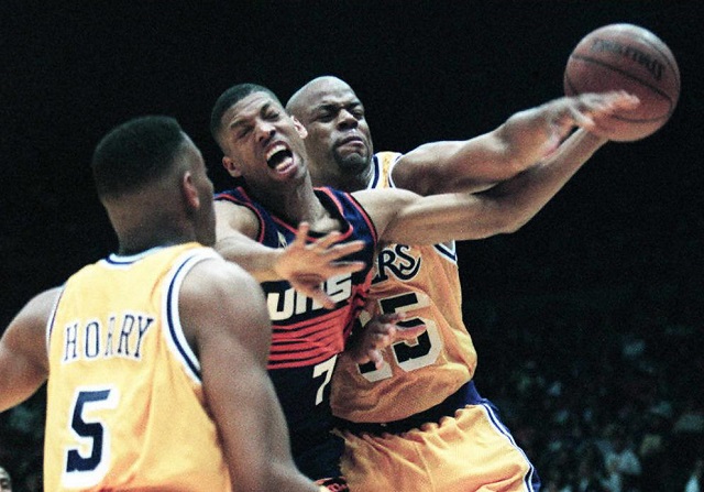 Kevin Johnson of the Phoenix Suns is fouled by Sean Rooks of the Los Angeles Lakers. 
