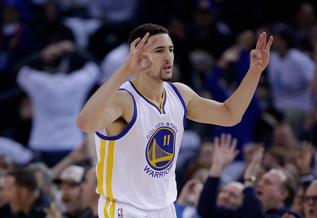 Klay Thompson gestures to his teammates during a game.