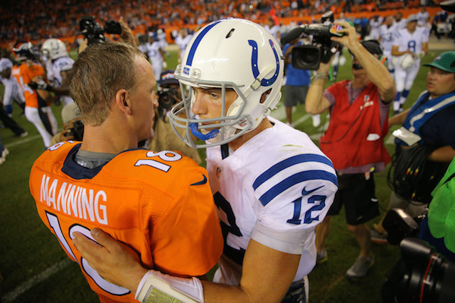 Peyton Manning shakes hands with new Colts quarterback Andrew Luck