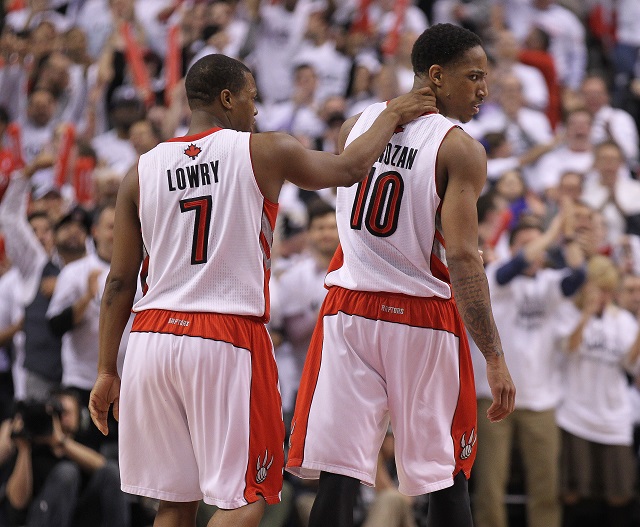 Kyle Lowry and DeMarcus DeRozan walk off the court together.