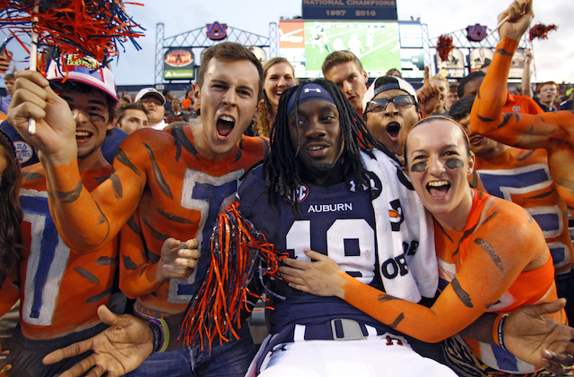 Fans painted like the Auburn Tiger celebrate a touchdown with former Auburn wide receiver Sammie Coates