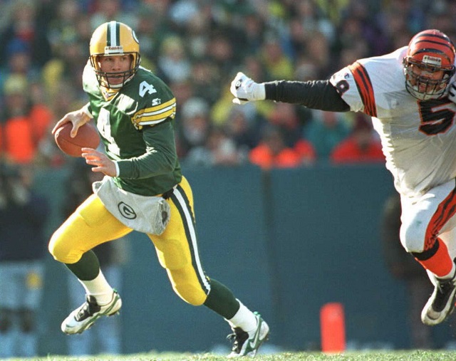 Brett Favre roles to his right to look for a receiver