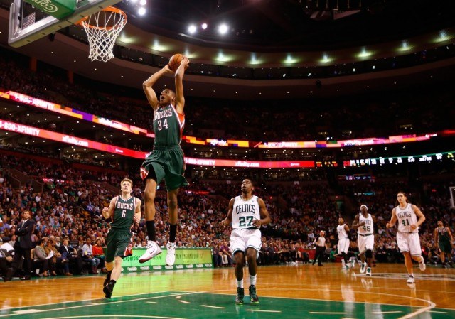 Giannis Antetokounmpo of the Milwaukee Bucks flies through the air for a dunk | Jared Wickerham/Getty Images