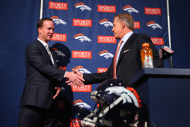 Peyton Manning shakes John Elways' hand during a Broncos media event. 