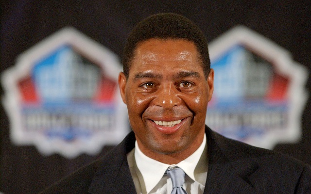 Marcus Allen smiles at a press conference.