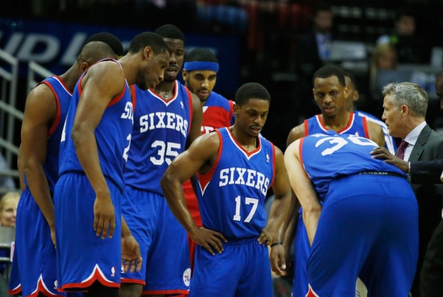HOUSTON, TX - MARCH 27: Head coach Brett Brown of the Philadelphia 76ers waits with his team near the bench during a timeout during the game against the Houston Rockets at the Toyota Center on March 27, 2014 in Houston, Texas. NOTE TO USER: User expressly acknowledges and agrees that, by downloading and or using this photograph, User is consenting to the terms and conditions of the Getty Images License Agreement.