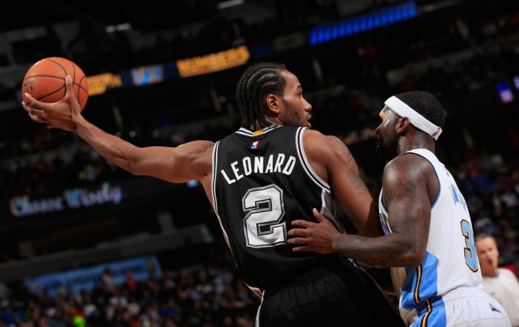 DENVER, CO - DECEMBER 14: Kawhi Leonard #2 of the San Antonio Spurs controls the ball against Ty Lawson #3 of the Denver Nuggets at Pepsi Center on December 14, 2014 in Denver, Colorado. The Spurs defeated the Nuggets 99-91. NOTE TO USER: User expressly acknowledges and agrees that, by downloading and or using this photograph, User is consenting to the terms and conditions of the Getty Images License Agreement. (Photo by Doug Pensinger/Getty Images)