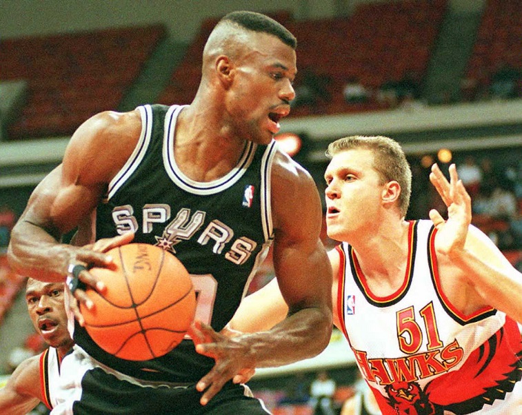 David Robinson defends the ball against an opponent. 