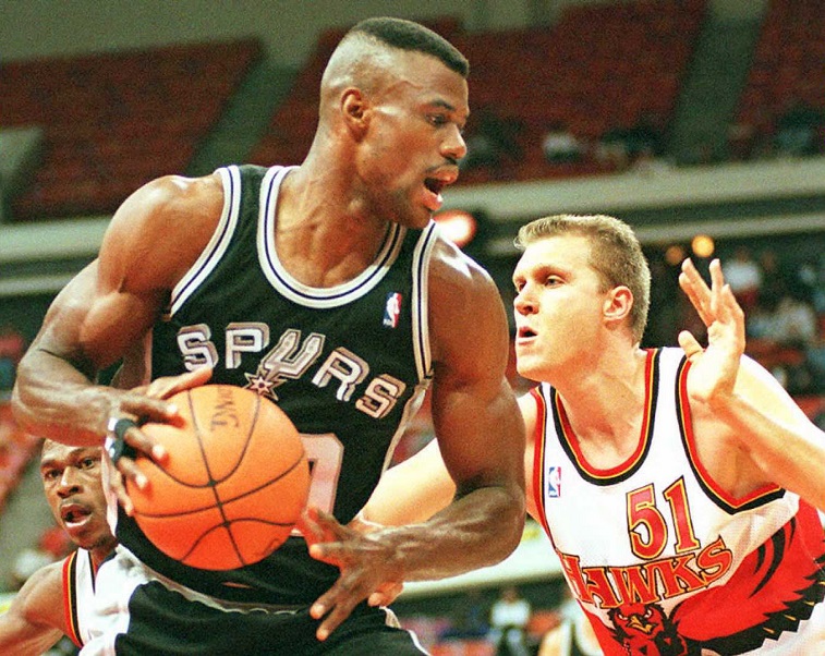 David Robinson defends the ball against an opponent.