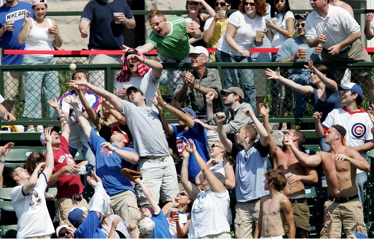 Fans go for a ball at Wrigley Field.
