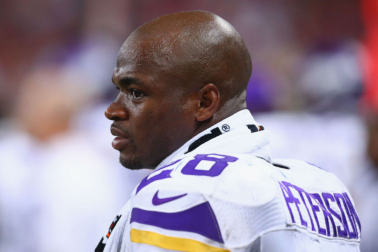 ST. LOUIS, MO - SEPTEMBER 7: Adrian Peterson #28 of the Minnesota Vikings looks on from the sideline during a game against the St. Louis Rams at the Edward Jones Dome on September 7, 2014 in St. Louis, Missouri.  The Vikings beat the Rams 34-6.