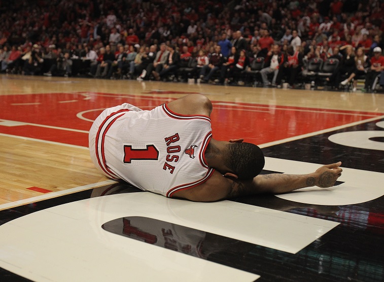 Derrick Rose laying on the court after being injured during a game