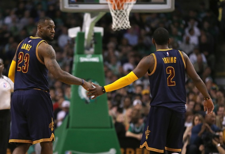LeBron James and Kyrie Irving low five.