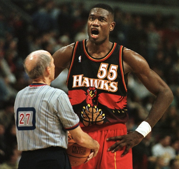 Dikembe Mutombo complains to referee
