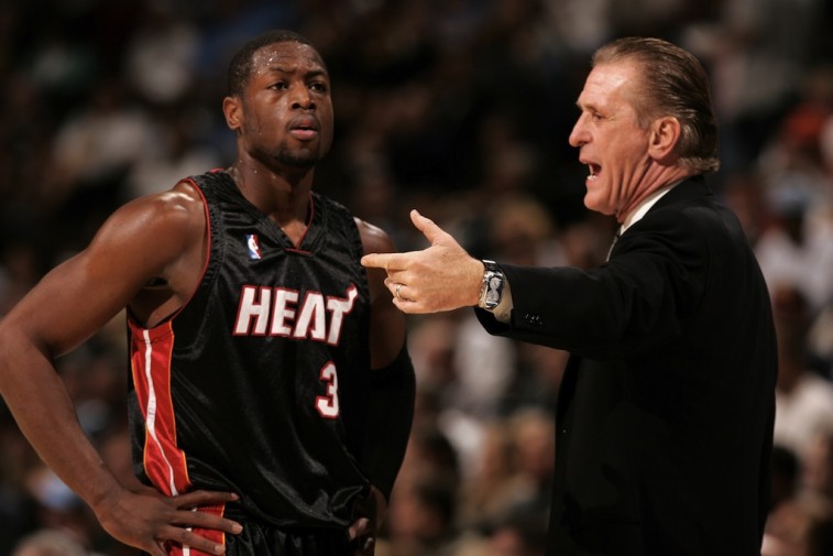 Dwyane Wade (L) and President of the Miami Heat, Pat Riley, discuss strategy. 