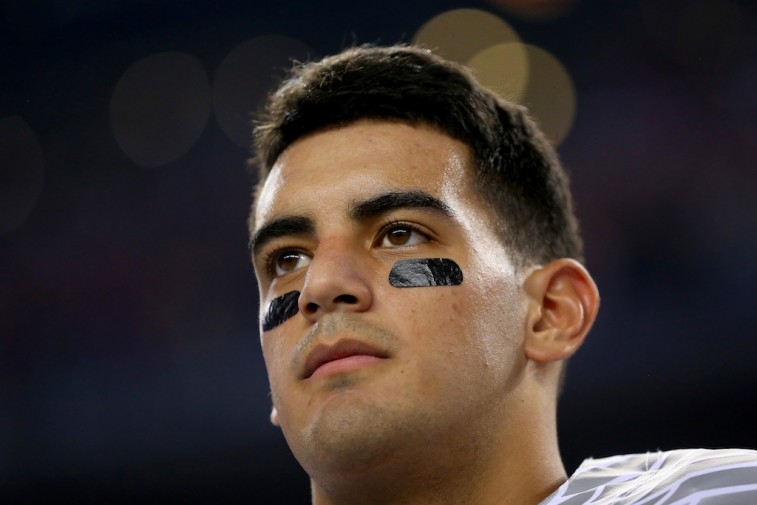 Marcus Mariota looks on before the national championship game