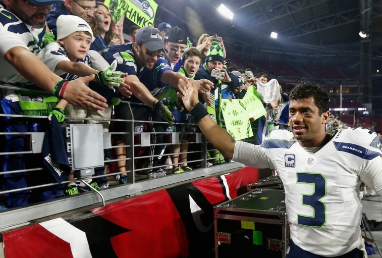 Russell Wilson celebrates with fans after the Arizona game