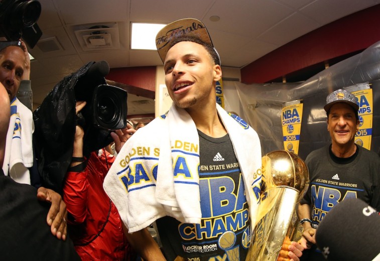 Stephen Curry with the Larry O'Brien Trophy