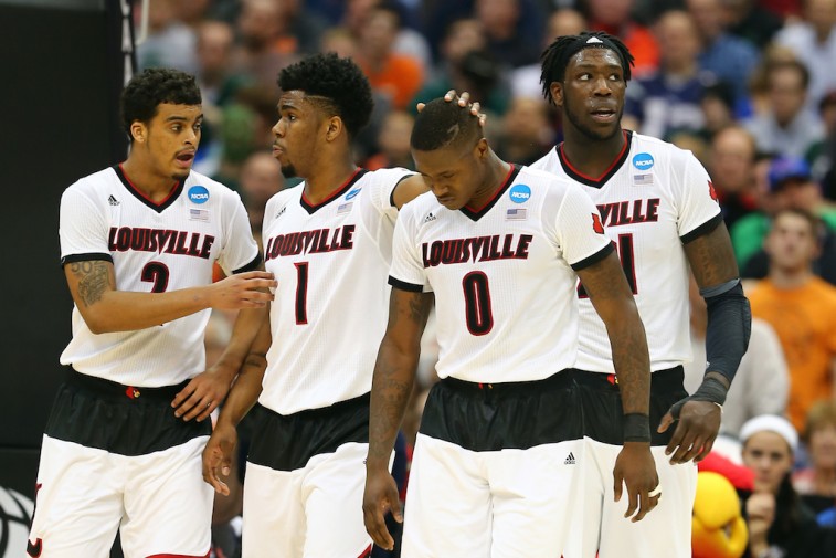 Louisville Cardinals react to basket during the NCAA Tournament