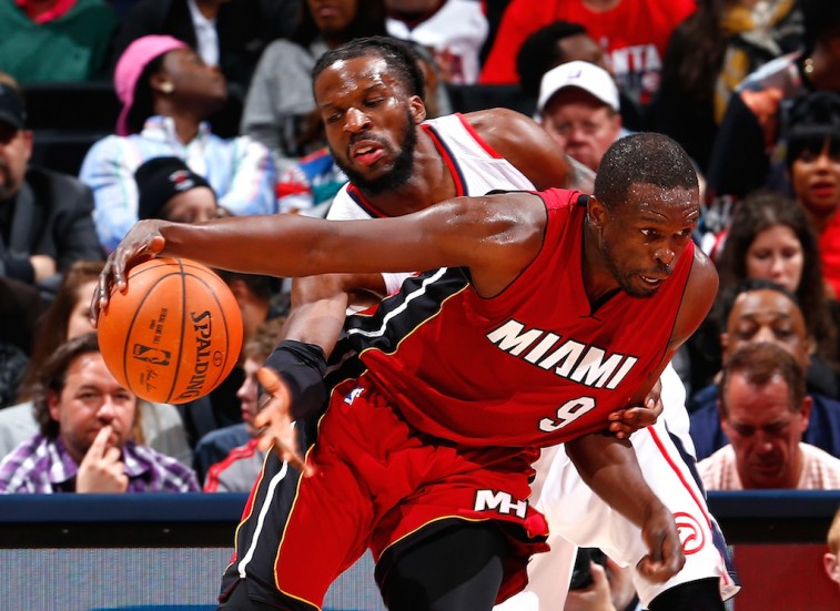 Luol Deng attempts to dribble past DeMarre Carroll