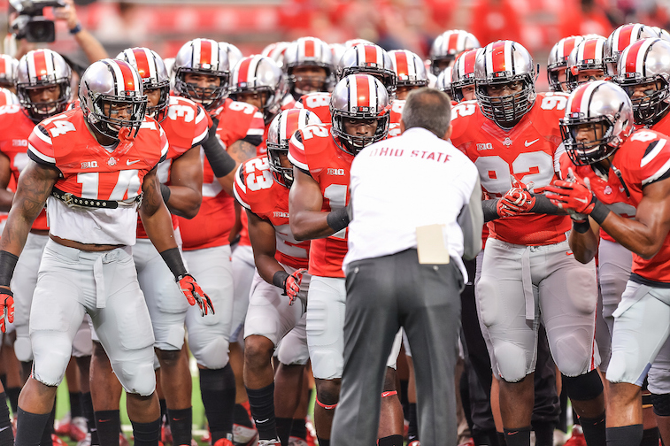 Head Coach Urban Meyer of the Ohio State Buckeyes rallies his team before a game against the Virginia Tech Hokies at Ohio Stadium on September 6, 2014 in Columbus, Ohio.  (Photo by Jamie Sabau/Getty Images)
