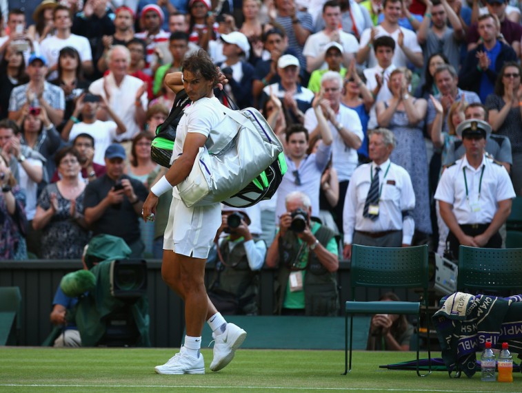 Rafael Nadal leaves the court dejected following his 2015 Wimbledon loss