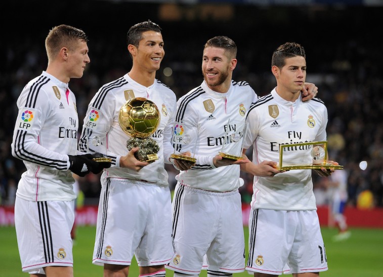 Real Madrid smiles with their trophies.