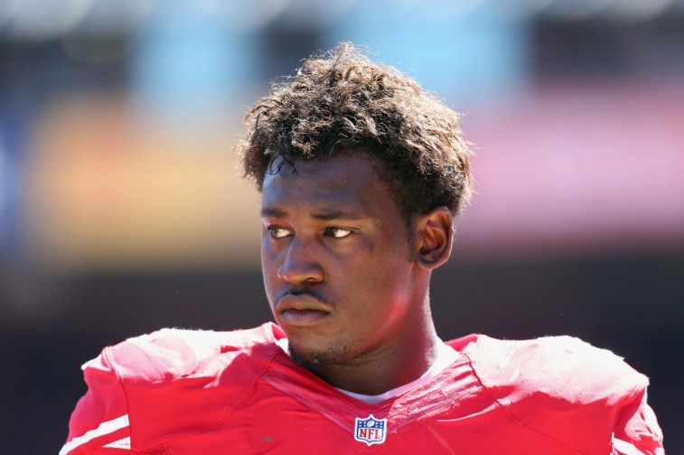 Aldon Smith looks on in a game against the Packers