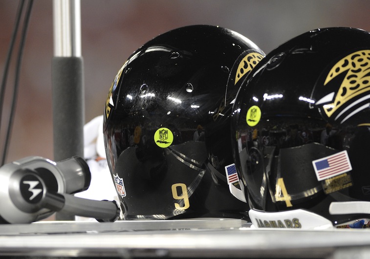 Helmets of the Jacksonville Jaguars quarterbacks display green 'radio' decals
