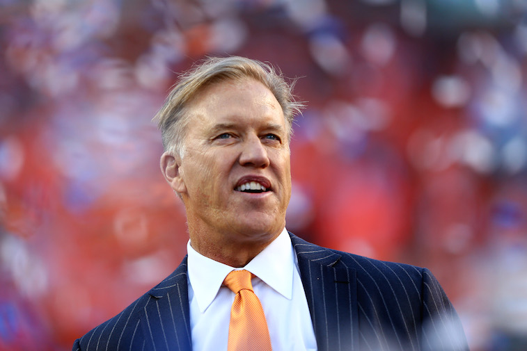 Denver Broncos General Manager John Elway watches a game from the sideline.
