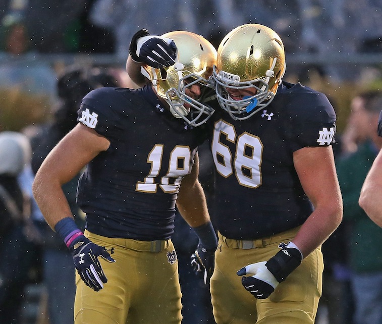 SOUTH BEND, IN - OCTOBER 04: Mike McGlinchey #68 of the Notre Dame Fighting Irish hugs Ben Koyack #18 after Koyack caught the game-winning touchdown pass against the Standford Cardinal at Notre Dame Stadium on October 4, 2014 in South Bend, Indiana. Notre Dame defeated Standford 17-14.