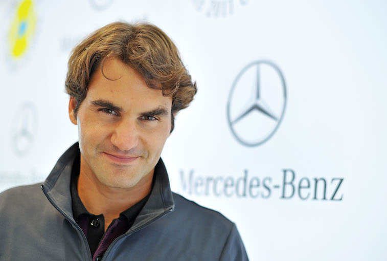 Roger Federer smiling on the red carpet of an event. Roger Federer smiling on the red carpet of an event.