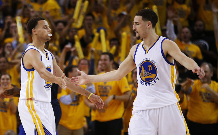 Stephen Curry and Klay Thompson slap hands during Game 1 of the 2015 NBA Finals