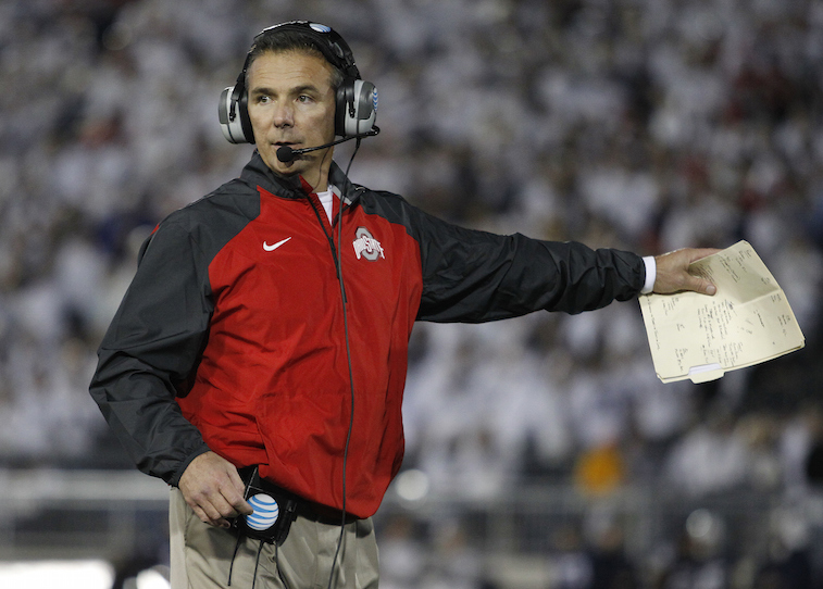 Urban Meyer, head coach of the Ohio State Buckeyes, coaches during a game.