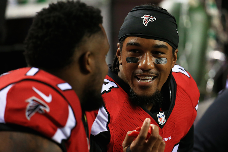 Vic Beasley (#44) talks to a teammate on the sidelines during a preseason game against the Tennessee Titans