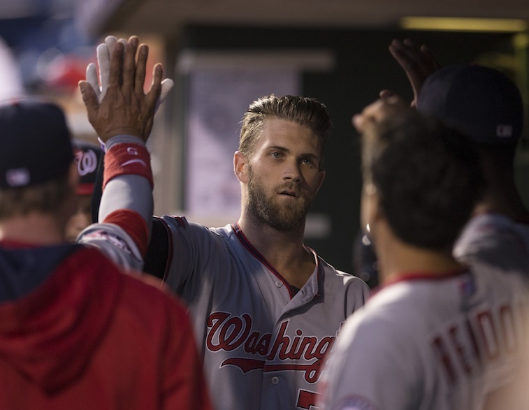 Bryce Harper celebrates in dugout with teammates