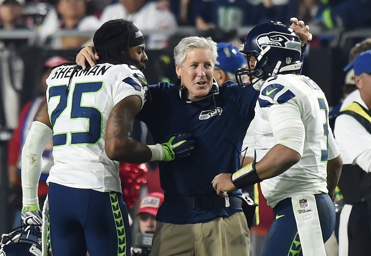 Pete Carroll celebrates with Richard Sherman and Russell Wilson